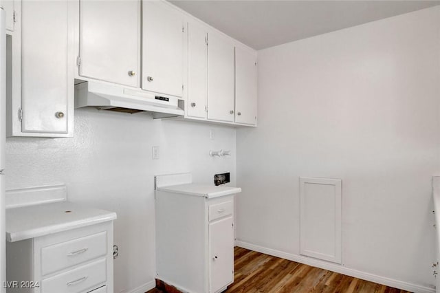 laundry area with dark wood-type flooring