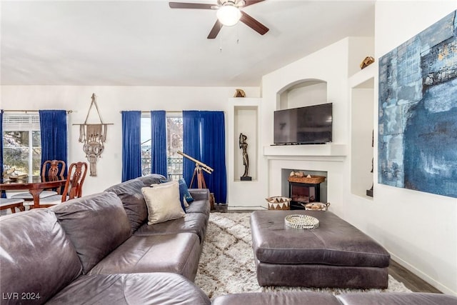 living room featuring hardwood / wood-style floors and ceiling fan