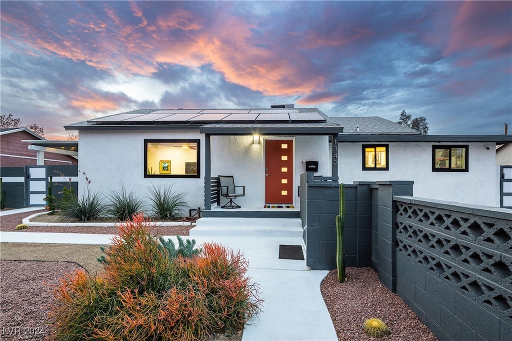 view of front of property with solar panels