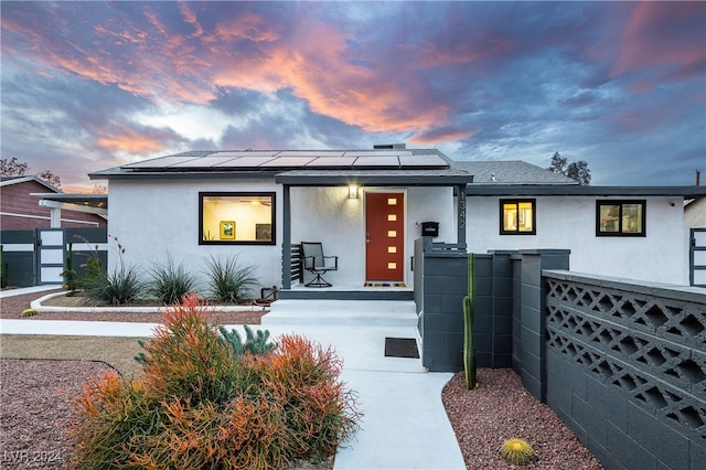 view of front of property with solar panels