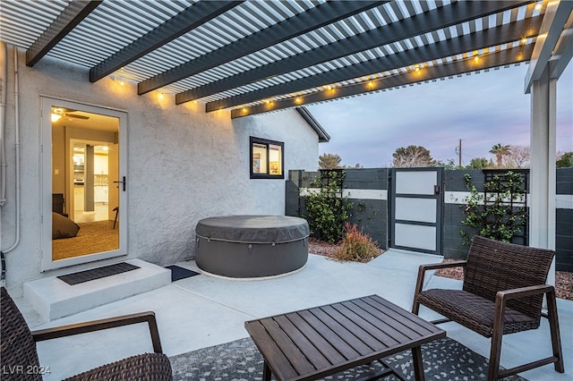 patio terrace at dusk featuring a pergola