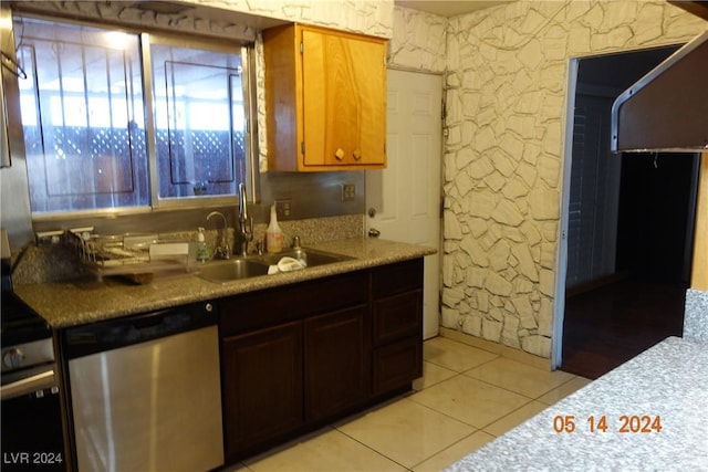 kitchen with sink, light tile patterned floors, and stainless steel dishwasher