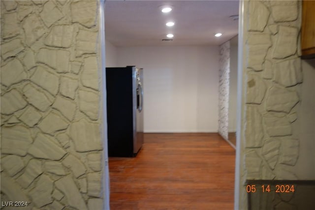 corridor with hardwood / wood-style floors