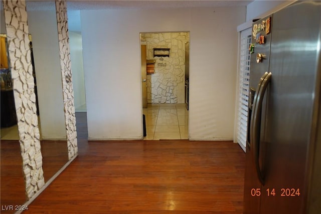 corridor featuring hardwood / wood-style floors and a textured ceiling