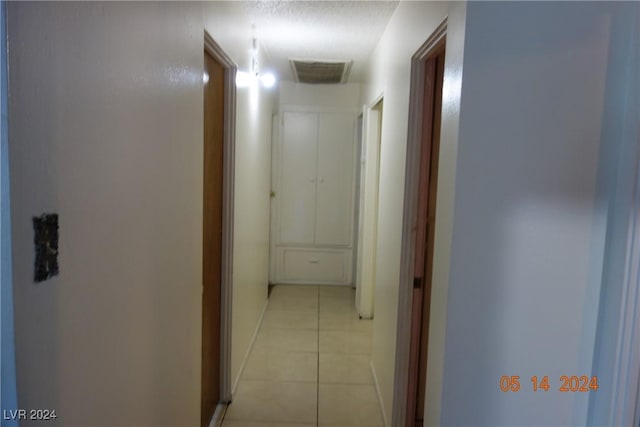 corridor featuring light tile patterned floors