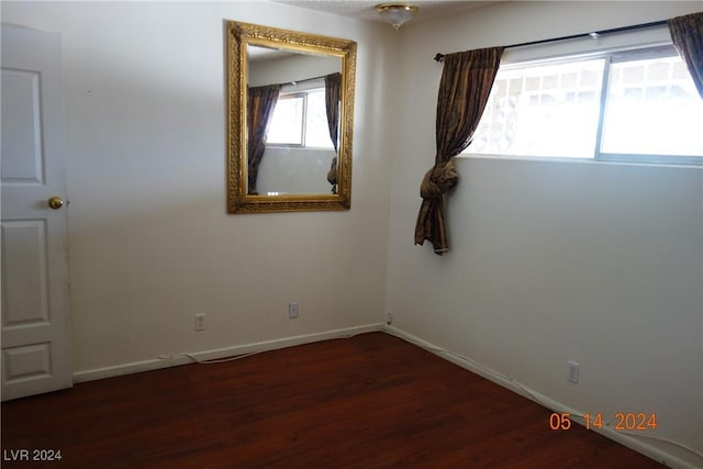 empty room with dark hardwood / wood-style floors