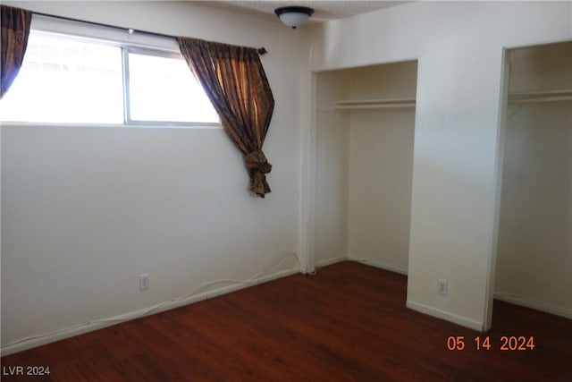 unfurnished bedroom featuring dark hardwood / wood-style floors