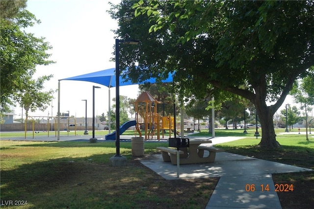 view of property's community with a playground and a yard