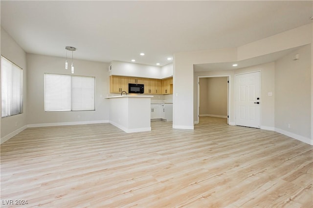 unfurnished living room featuring light wood-type flooring