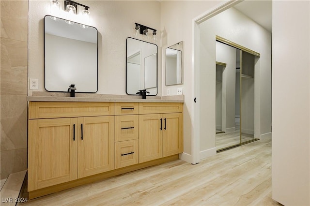 bathroom with vanity and wood-type flooring