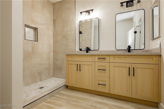 bathroom featuring hardwood / wood-style floors, vanity, and walk in shower