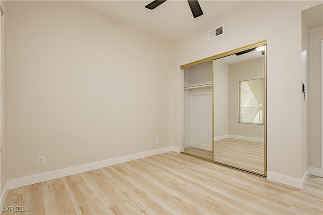 unfurnished bedroom featuring ceiling fan, a closet, and light hardwood / wood-style floors