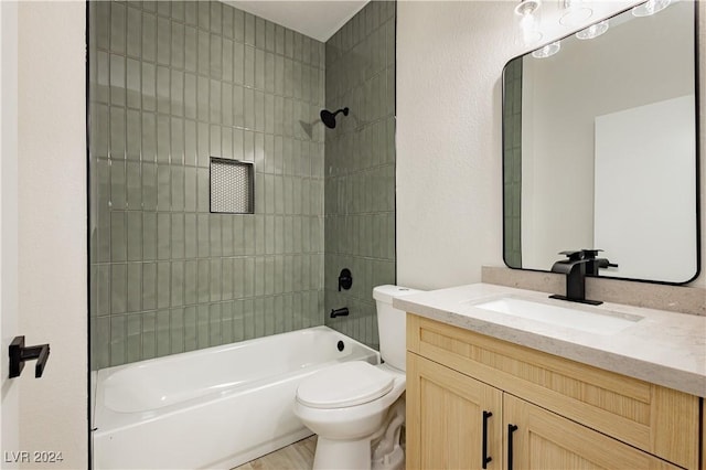 full bathroom featuring vanity, tiled shower / bath combo, and toilet