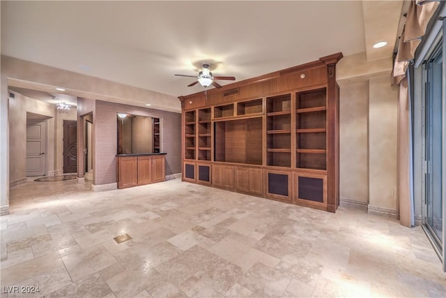 unfurnished living room with built in shelves and ceiling fan