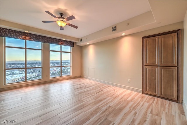 empty room featuring ceiling fan and light hardwood / wood-style flooring