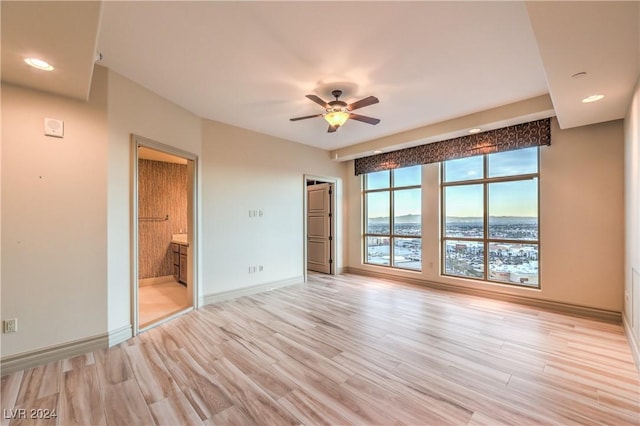 unfurnished room featuring light wood-type flooring and ceiling fan