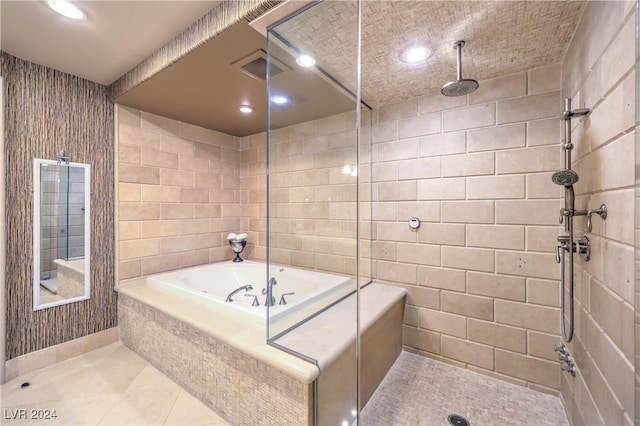 bathroom with tile walls, tile patterned floors, and independent shower and bath