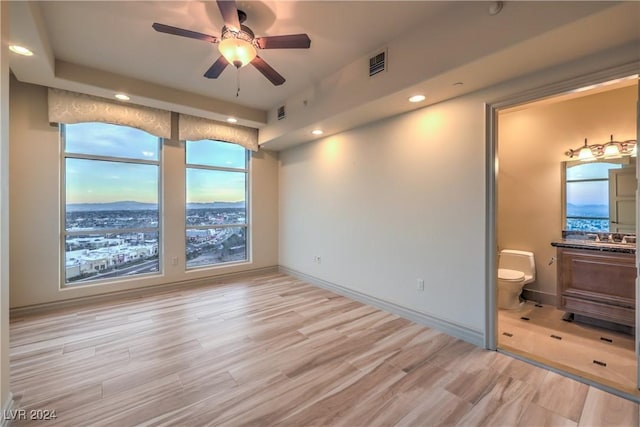 unfurnished room with ceiling fan and light hardwood / wood-style flooring