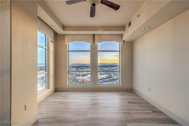 spare room featuring light wood-type flooring and ceiling fan