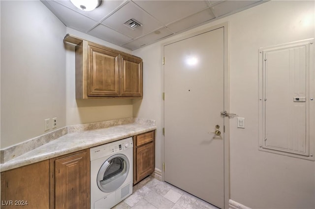 laundry room featuring electric panel, washer / clothes dryer, and cabinets