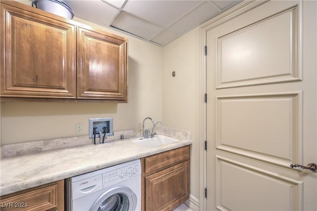 laundry area with sink, cabinets, and washer / clothes dryer