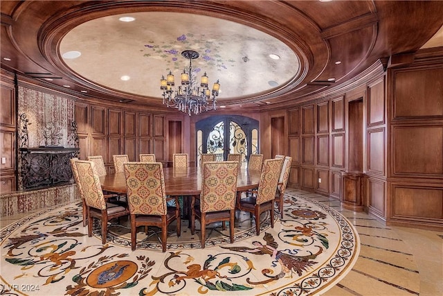 dining room with wood walls, a chandelier, and ornamental molding