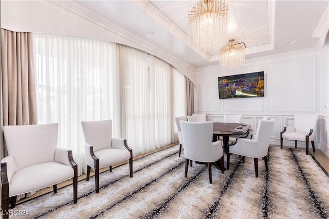 dining area featuring ornamental molding, an inviting chandelier, and a tray ceiling