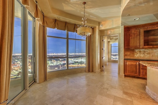 unfurnished dining area with an inviting chandelier