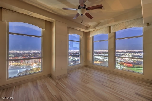 unfurnished sunroom featuring ceiling fan