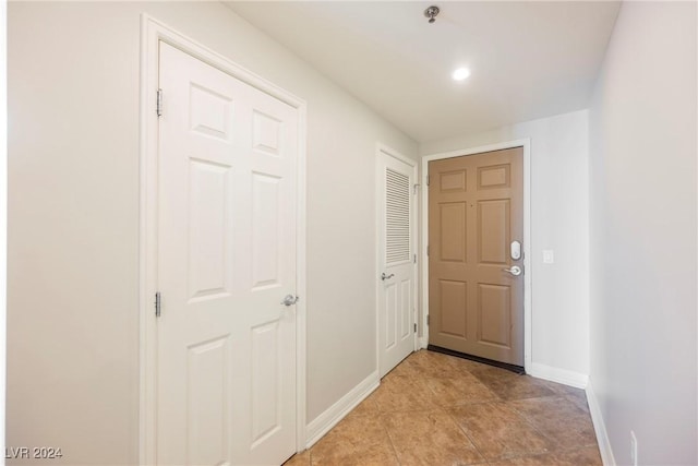 hall featuring light tile patterned flooring