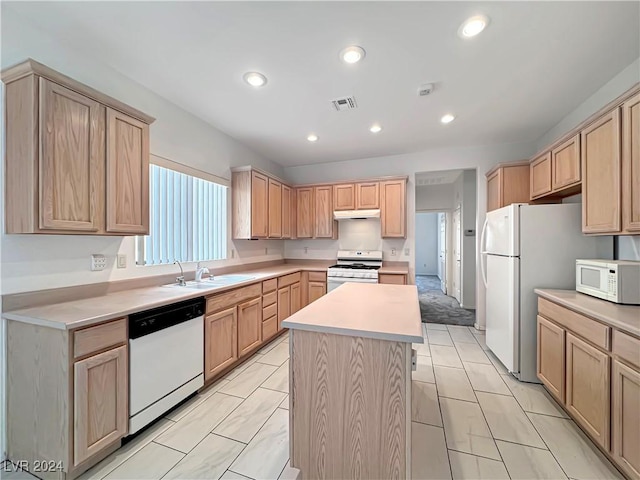 kitchen with a center island, light brown cabinets, white appliances, and sink