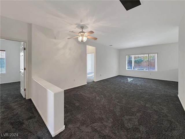 carpeted spare room with ceiling fan