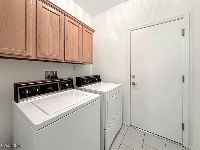 washroom with washing machine and dryer and cabinets