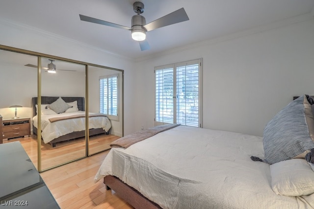 bedroom featuring ceiling fan, a closet, ornamental molding, and light hardwood / wood-style flooring