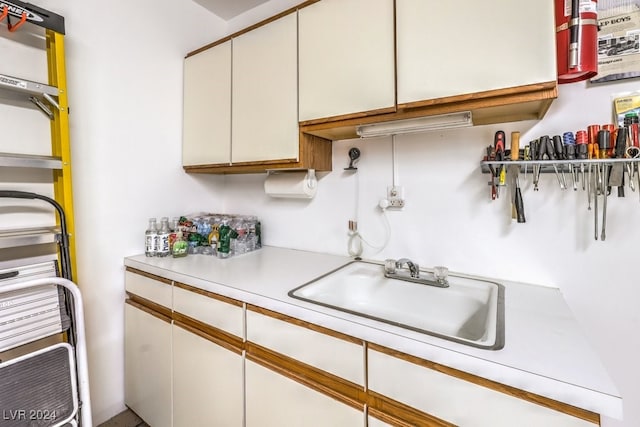 kitchen featuring white cabinetry and sink