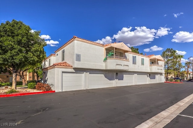 view of front of home with a balcony and a garage