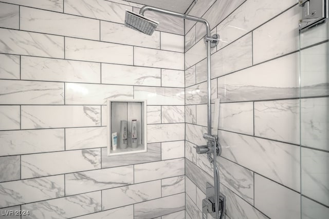 bathroom with a tile shower