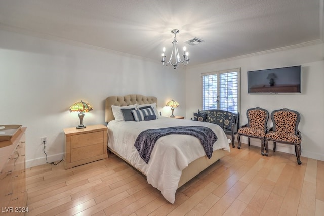 bedroom featuring a chandelier, light wood-type flooring, and crown molding