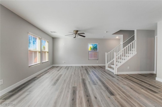 unfurnished living room with ceiling fan, a healthy amount of sunlight, and light hardwood / wood-style floors