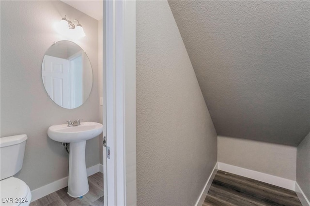 bathroom featuring wood-type flooring, toilet, and sink