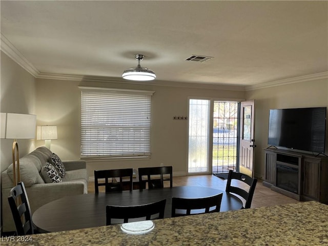 dining room featuring crown molding