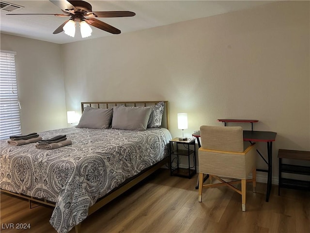 bedroom featuring hardwood / wood-style flooring and ceiling fan