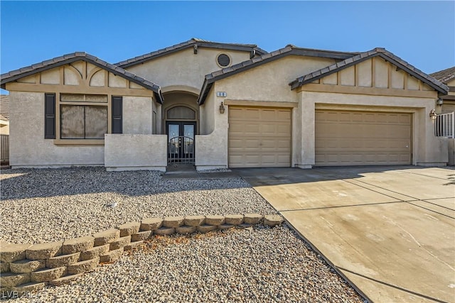 view of front of home with french doors and a garage