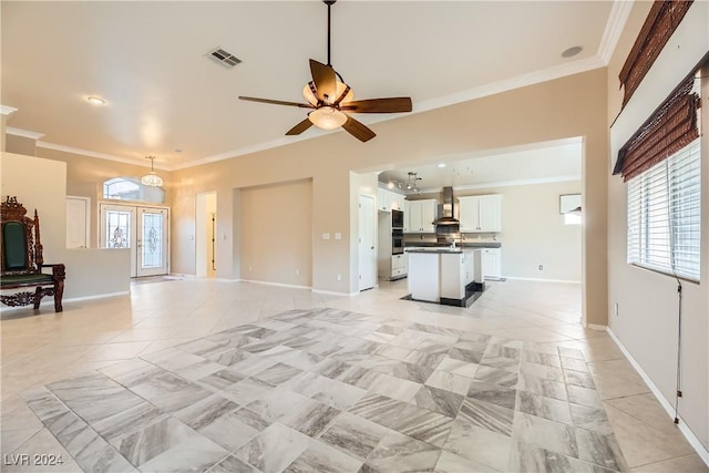 living room with french doors, ceiling fan, ornamental molding, and light tile patterned flooring