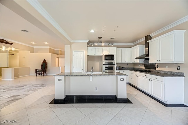 kitchen with white cabinetry, crown molding, appliances with stainless steel finishes, and wall chimney range hood