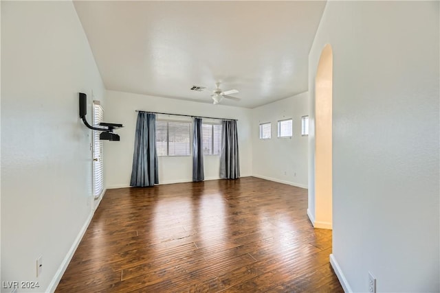 spare room with dark hardwood / wood-style flooring and ceiling fan