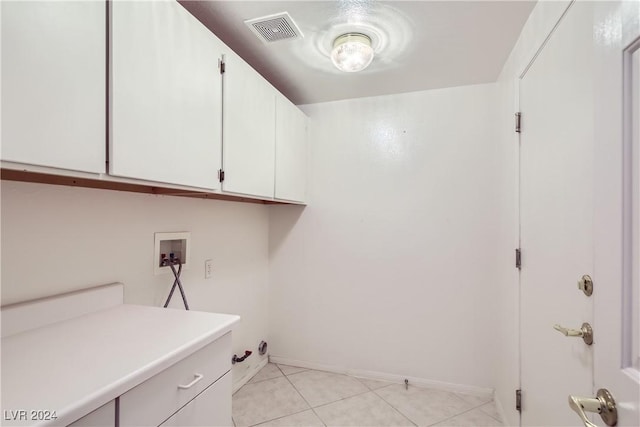 laundry area with gas dryer hookup, light tile patterned floors, cabinets, and washer hookup