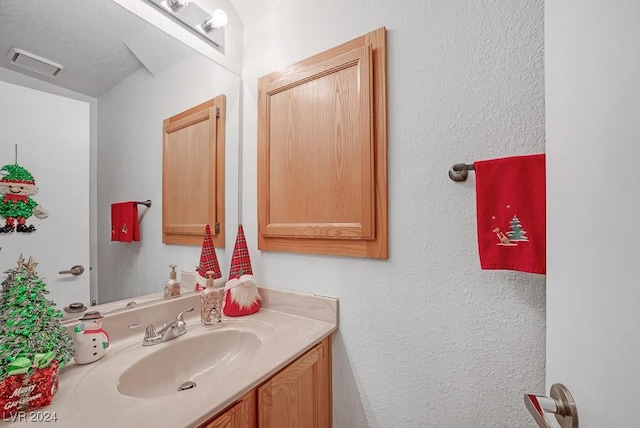 bathroom featuring vanity and a textured ceiling