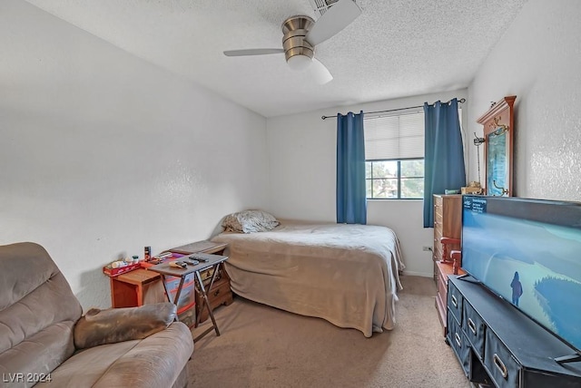 carpeted bedroom featuring a textured ceiling and ceiling fan