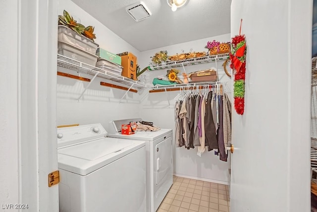 clothes washing area with washing machine and dryer